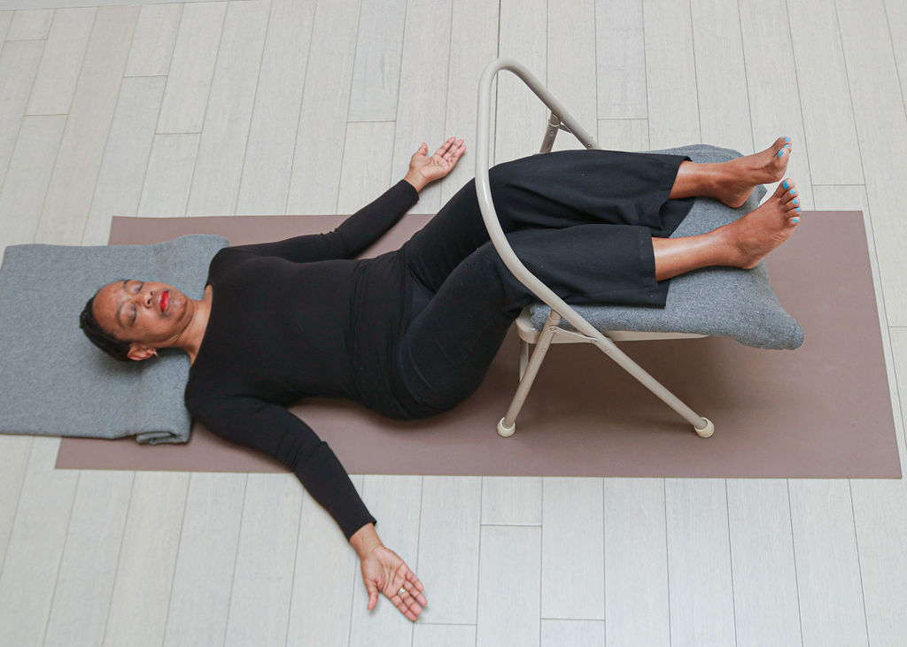 Savasana with calves resting on chair